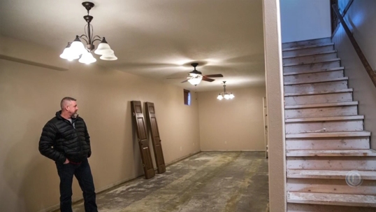 Jonathan Goodier, one of the residents displaced by the gas leak stands in his temporarily abandoned home.