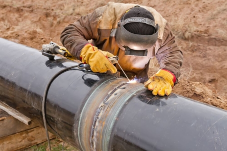 welder working on pipeline