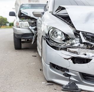 Two silver cars after a car crash
